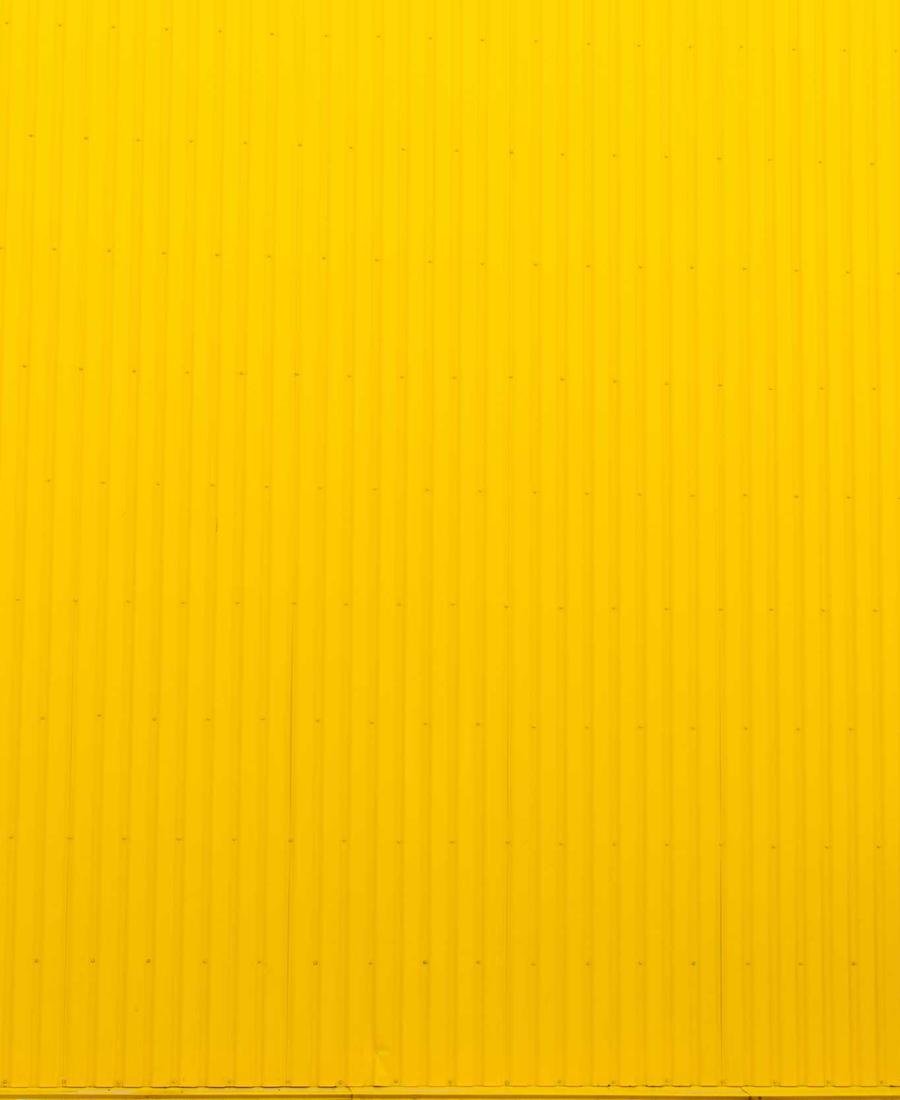 A wall of yellow corrugated metal
