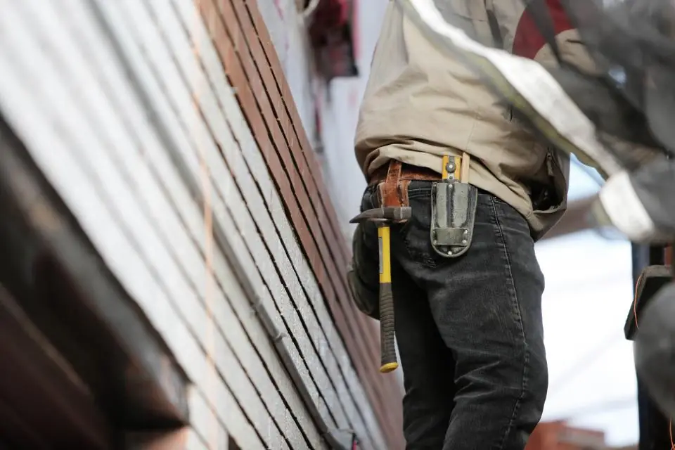 A tradesperson with a tool belt at work